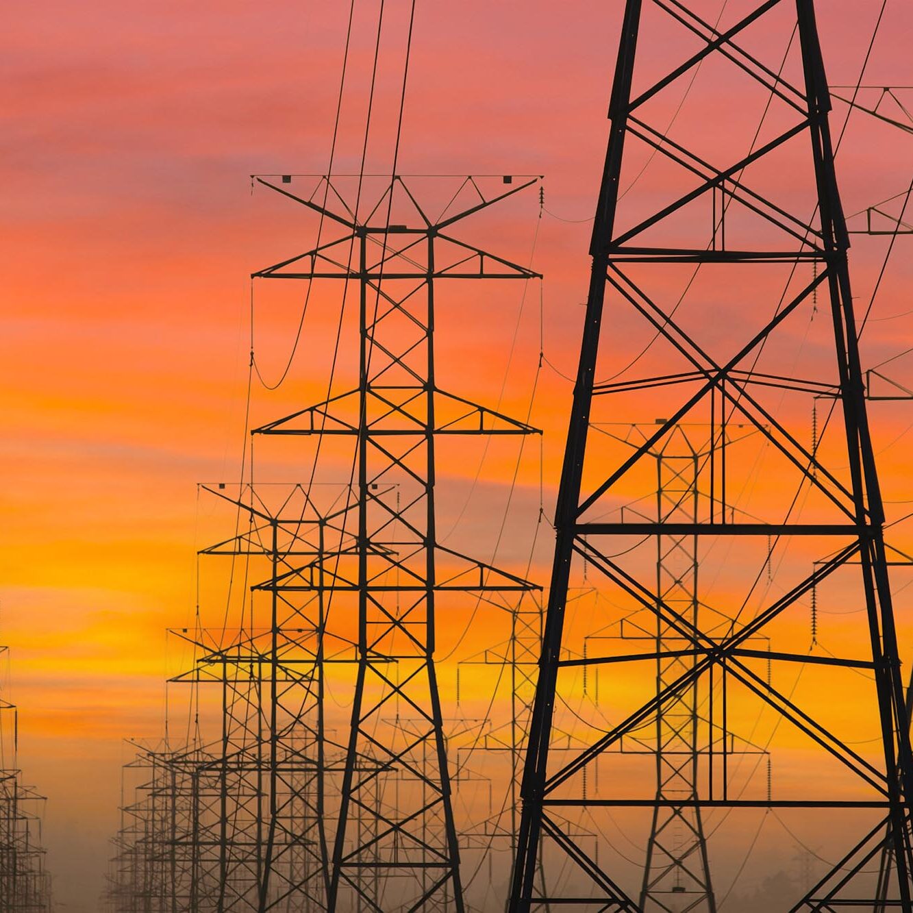 Power Towers with Sunrise Sky Three rows of power towers with sunrise sky in Los Angeles, California.